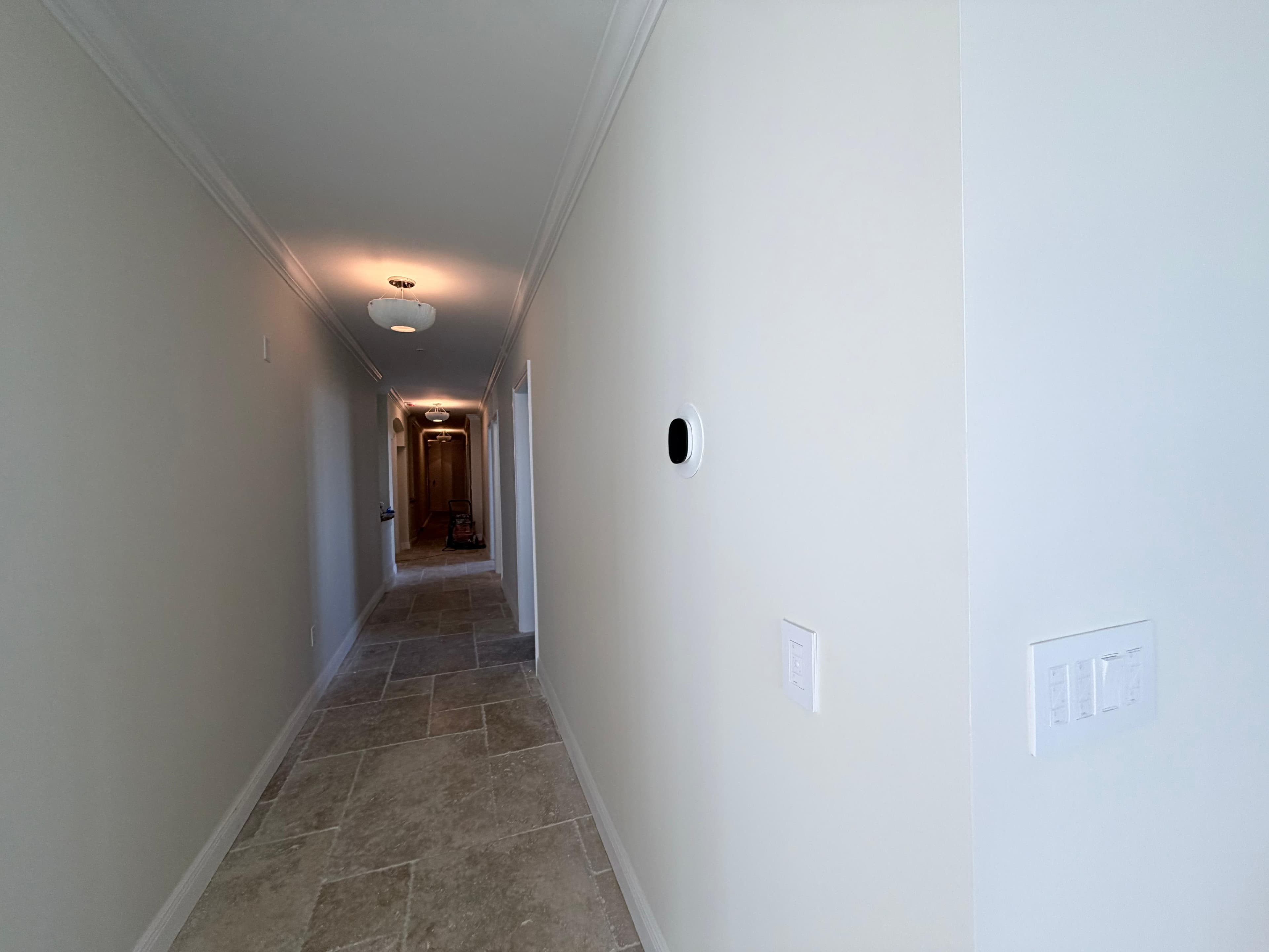 Hallway with finished travertine flooring — JMF Remodeling